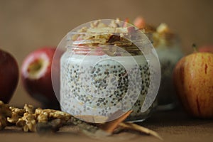 Overnight oats with apple and almonds. Made by soaking rolled oats and chia seeds in milk served with chopped apples, cinnamon,