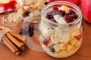 Overnight oats with apples and cranberries in a mason jar photo