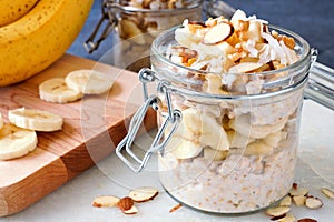 Overnight oats with bananas and nuts in glass canning jars photo