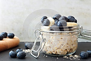 Overnight oats with blueberries and bananas, with white and black background