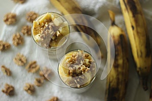 Overnight oats with ripe plantain and walnuts. Made by soaking rolled oats and chia seeds in milk served with sliced plantains,