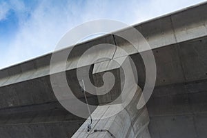 Overpass concrete with light below view on blue sky background