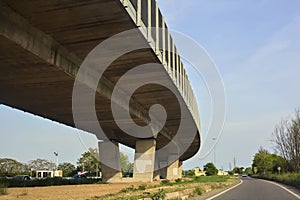 Overpass next to a road at sunset in the italian countryside