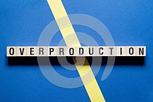 Overproduction word concept on cubes photo