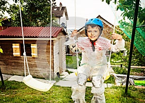 Overprotective boy in bubble wrap swing on swings