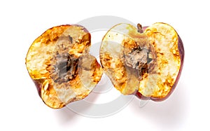 Overripe apple with rotten core on white background