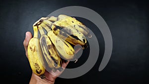 Overripe bananas almost rot and dry.  on black background