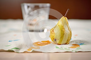 overripe pear with leaking juice, on a napkin