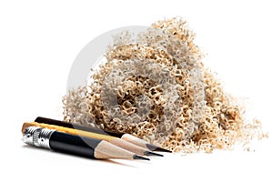 Oversharpened pencil in front of the heap of shavings. Concept of the fruitless design or art work