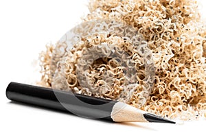 Oversharpened pencil in front of the heap of shavings. Concept of the fruitless design or art work