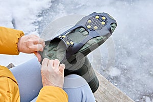 Overshoes for ground grip, steel studs that can traction on ice and snow.