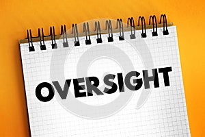 Oversight - an unintentional failure to notice or do something, text concept on notepad photo