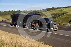 Oversize Load / Black Kenworth Semi-Truck photo