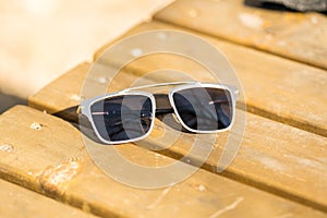 Oversized sunglasses design with big black flat lenses closeup shoot outside in a summer day . Selective focus