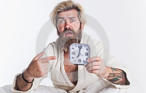 Oversleeping. Shocked bearded man in bed with alarm clock. Late For Work, Bad Morning, Tardiness Concept.