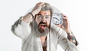 Overslept bearded man with alarm clock. Oversleeping, late for work, bad morning, tardiness concept.