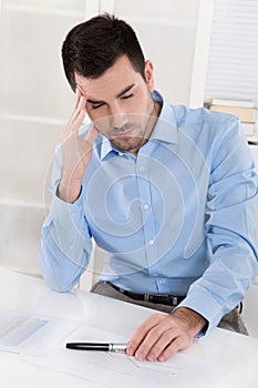 Overstrained and overworked businessman with headache: Portrait