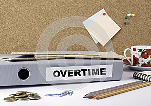 Overtime - folder on white office desk