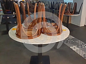 Overturn stool on wooden table photo