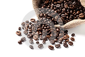 Overturned bag with roasted coffee beans on white background