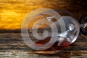 Overturned glass of wine on floor