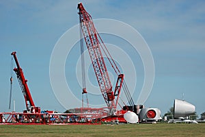 Overview of the assembly of the gigantic construction crane together with a mobile crane, for building a wind turbine