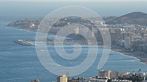 Overview of city by the sea at sunset