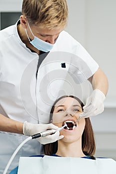 Oral hygiene, dentist doing Scaling and brushing procedure photo