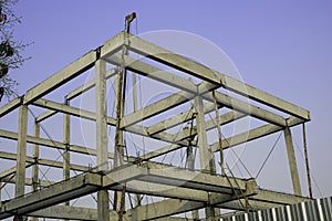 Overview house strong structure cement purlin and rafter. Long steel tripod heavy duty for lift material forr building home. worke photo