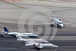 Overview of the private jet ramp at McCarran International Airport Las Vegas with multiple luxury jets parked on the tarmac