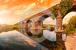 Overview at sunset of the Ancient Bridge of Orosei on the river Cedrino, Sardinia