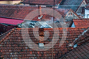 Overview of tile rooftops of old houses. Old buildings architecture