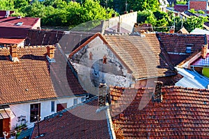Overview of tile rooftops of old houses. Old buildings architecture