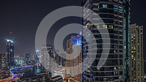 Overview to JBR and Dubai Marina skyline with modern high rise skyscrapers waterfront living apartments aerial night