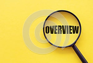 Overview word. Summary and recap concept. Magnifying glass on yellow background