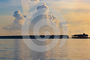 Overwater bungallows at sunrise Laccadive Sea Maldives