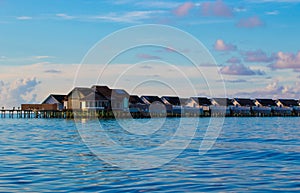 Overwater bungallows at sunrise Laccadive Sea Maldives