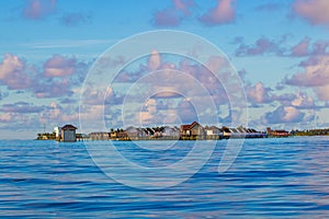 Overwater bungallows at sunrise Laccadive Sea Maldives