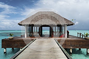 Overwater bungalow in a  sandy beach in Maldives Island, Pacific Ocean, Asia