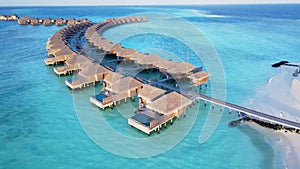 Overwater Bungalows stretched to an Island. Early morning above Luxury resort on Vakkaru Island, Maldives.