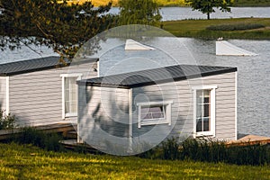 Overwater wooden bungalows on the lake with a wake park equipment