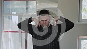 Overweight adult man warming up in the gym.