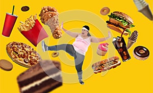 Overweight Asian woman fighting off junk food