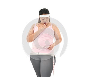 Overweight Asian woman measuring her waistline fat tummy isolated on white background