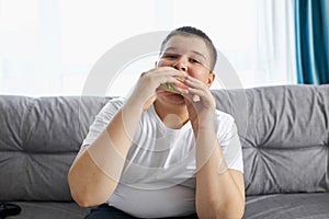 Overweight boy lead unhealthy lifestyle photo