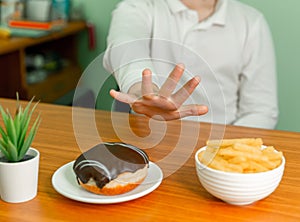 Overweight boy rejecting unhealthy food. Child refuses to eat