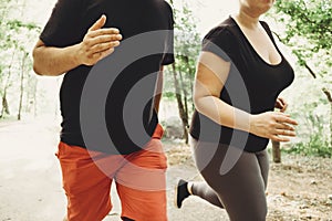 Overweight couple losing weight running together