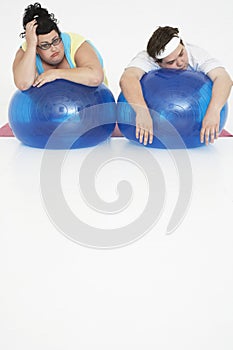 Overweight Couple Resting On Exercise Balls