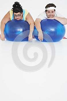 Overweight Couple Resting On Exercise Balls