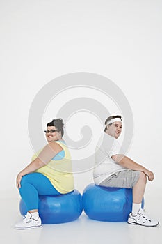 Overweight Couple Sitting On Exercise Balls